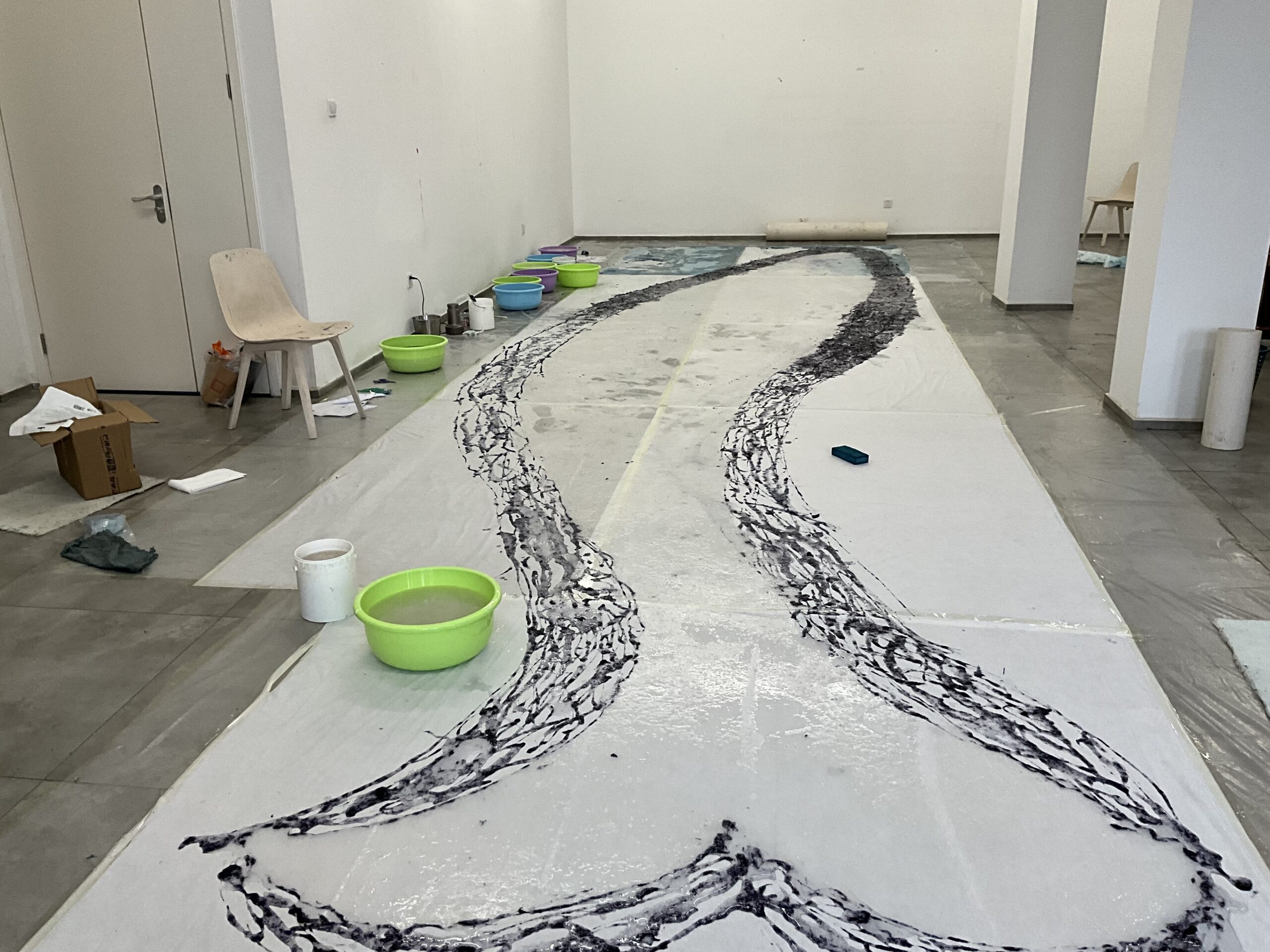 Buckets and abstract artwork on floor