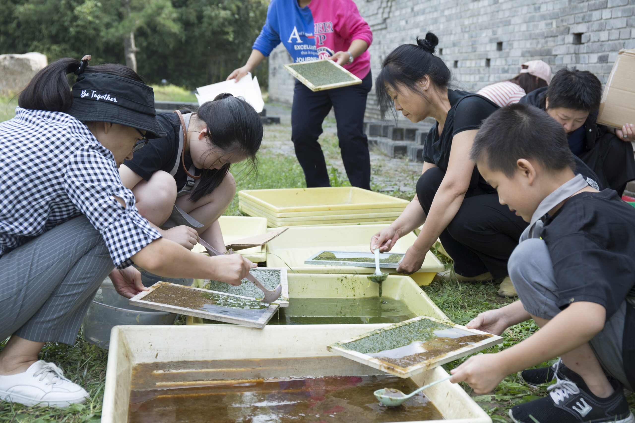 Group making paper outdoors