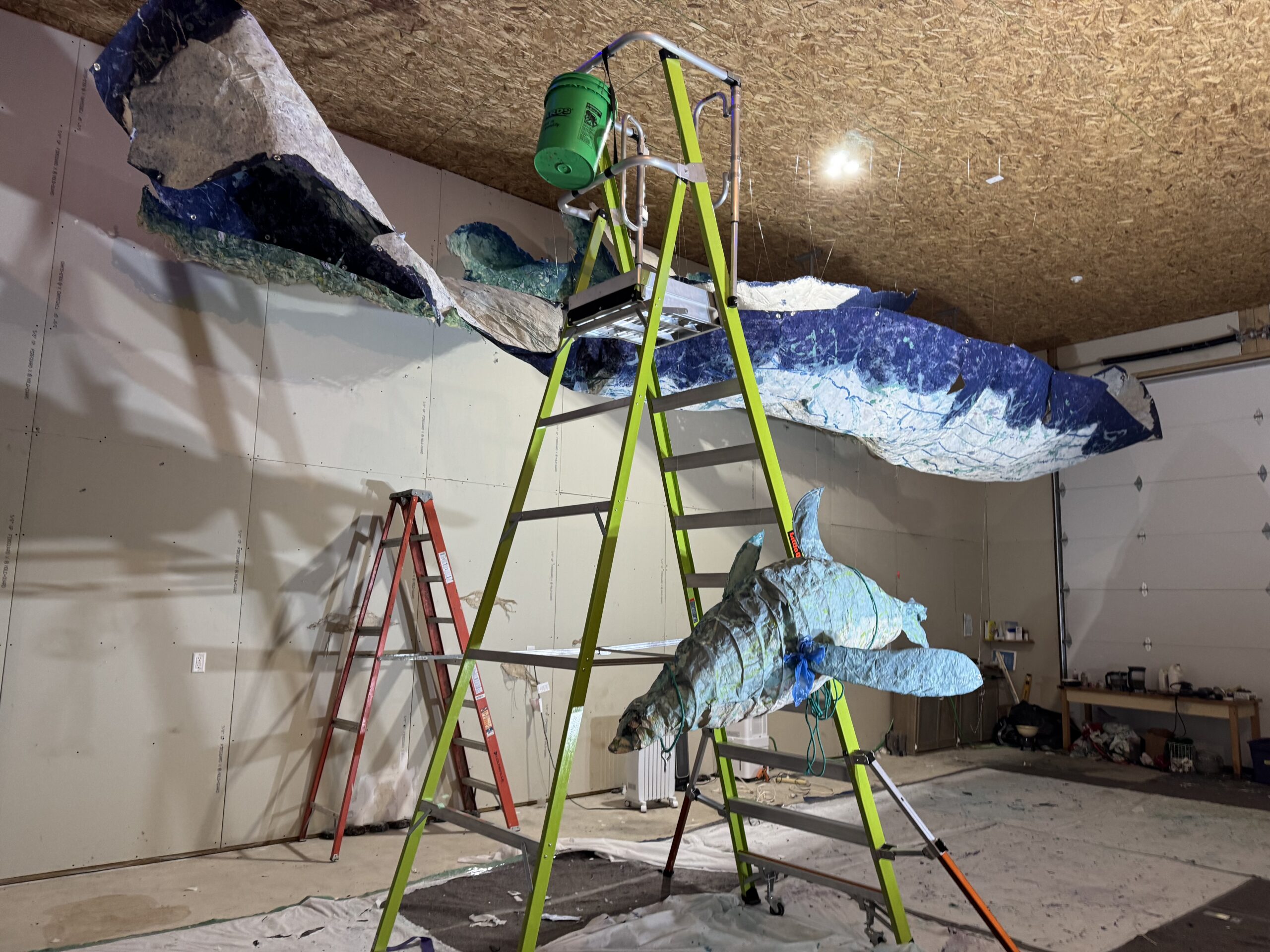 Large wave sculpture in a workshop.