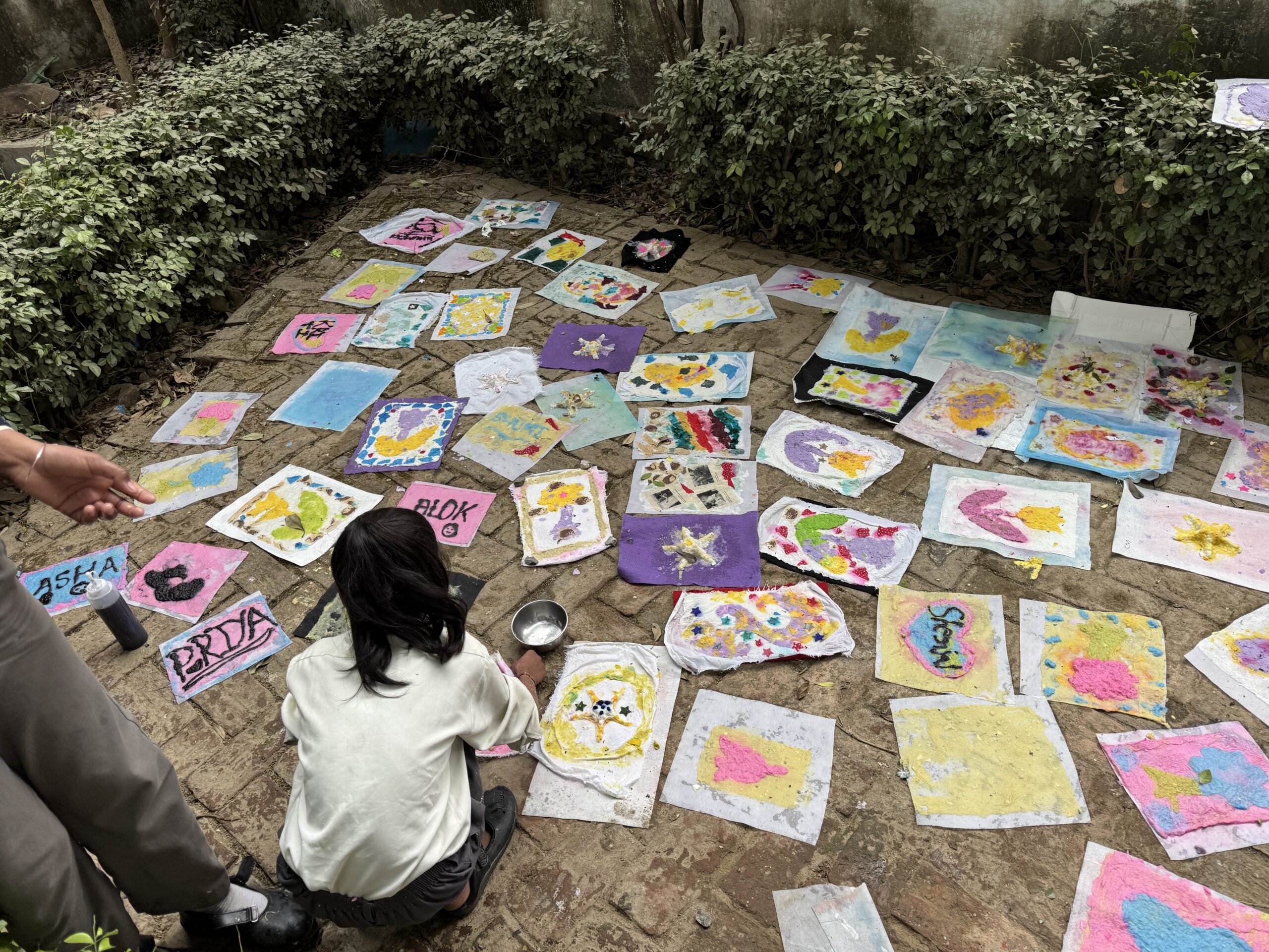Colorful paintings drying on the ground