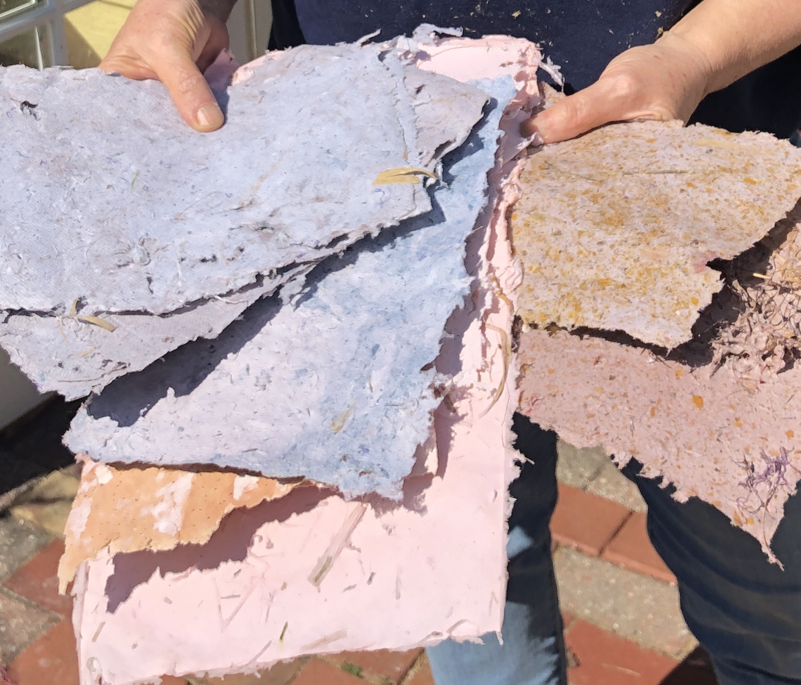 Person holding colorful handmade paper