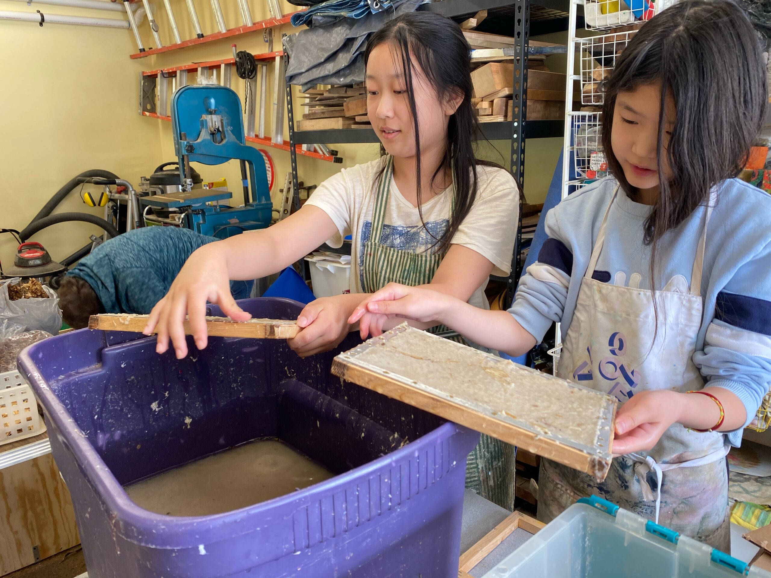 Young girls engaged in papermaking activity